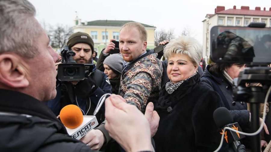Yauhen Merkis is in the center, with the microphone